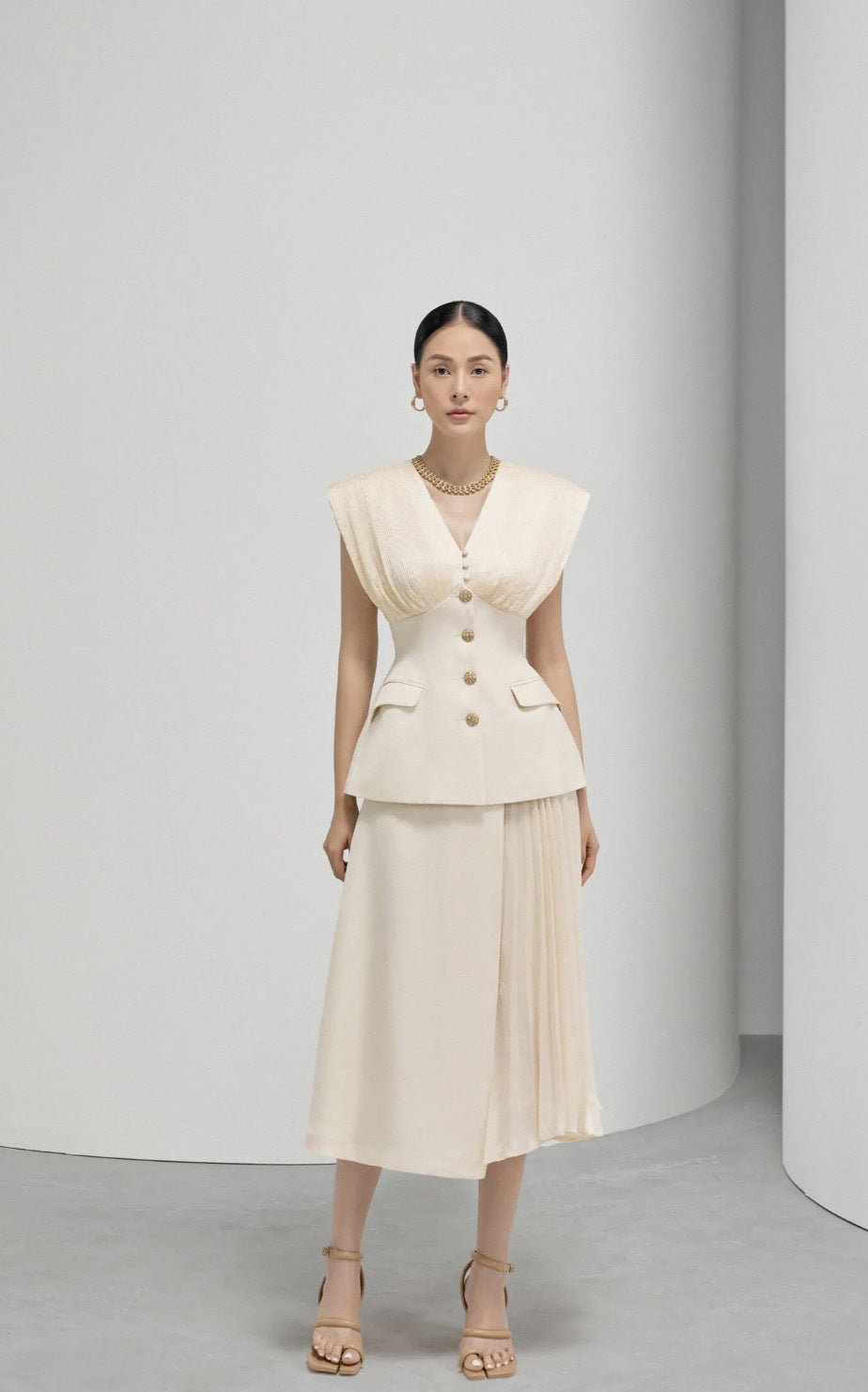 Elegant Beige Sleeveless Dress with Pleated Design and Gold Buttons